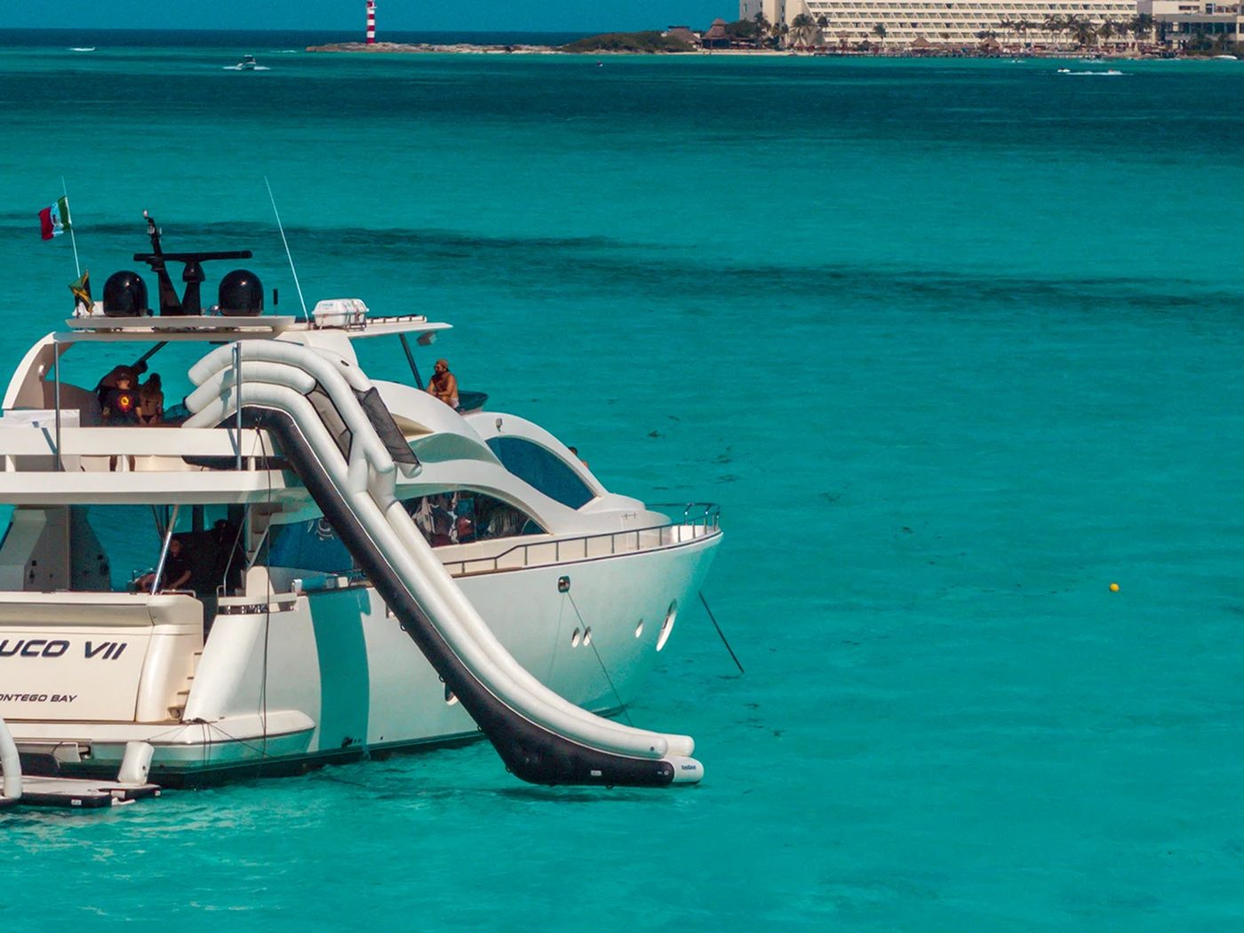 A Maritime yacht anchored in the shallows off Canc&uacute;n, slide down to the water