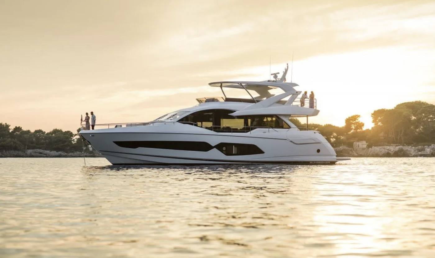 A Maritime yacht at golden hour off a warm-water coastline