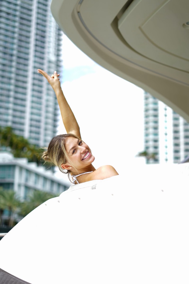 A guest on the foredeck against the Miami skyline