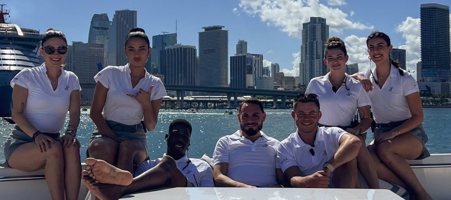 The Maritime crew aboard, with the Miami skyline behind them
